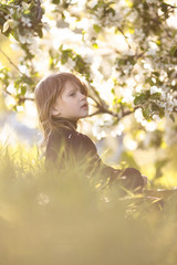 Baby girl and spring flowers, childhood emotions