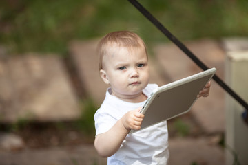 Kid Toddler with tablet outdoor, technology