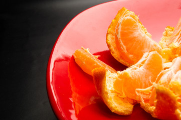 tangerines in a red plate