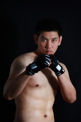 asian Fighter boxer standing strong on black background