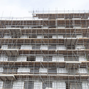 scaffolding on building site of new apartment building and sky