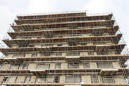 scaffolding on building site of new apartment building and sky