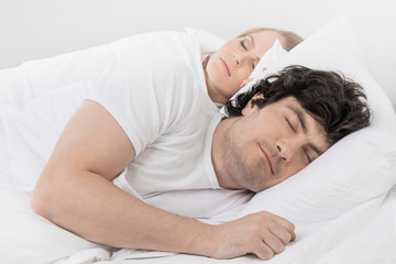 Fototapeta na wymiar Couple sleeping in bed