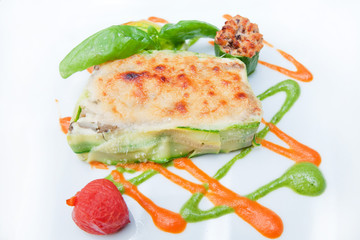parmigiana zucchini gratin parmigiana zucchini gratin with mozzarella cheese; basil; tomato and decorated with lovely colored sauces