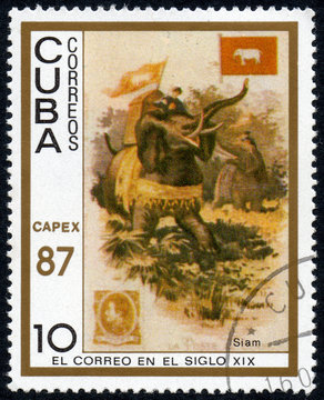 UKRAINE - CIRCA 2017: A stamp printed in Cuba, shows a man with a load moves on an elephant Siam, the series The mail in the nineteenth century, circa 1987