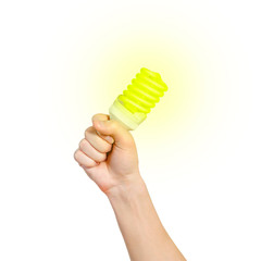 Closeup of man's hand holding energy saving lamp. Glows brightly with yellow light. Recycling, electricity, environment and ecology concept. The lamp is yellow. Isolated on white background