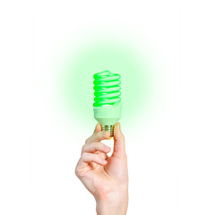 Closeup of man's hand holding energy saving lamp. Glows brightly with green light. Recycling,...