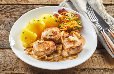 Portion of pork fillet and potatoes
