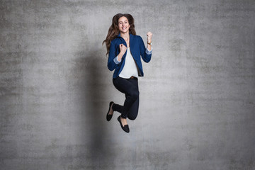 euphoric business woman jump wall