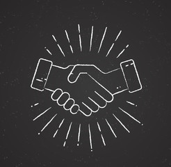 Handshake with sunburst on chalkboard