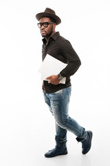 Handsome young african man dressed in shirt wearing hat