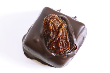 Chocolate candy with raisins on a white background 