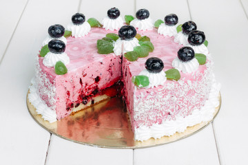 Сake with blueberries on a white wooden table