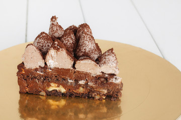 Сake with truffle on a white wooden table