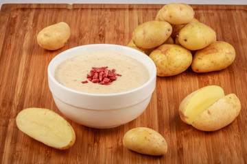 Potato soup on a wooden tray