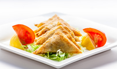 Fried pastries with cheese and vegetables