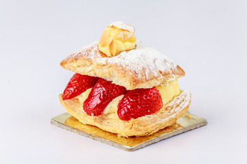 Vanilla cremeschnitte with strawberries on a white background