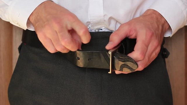 Businessman trying to take his trousers off