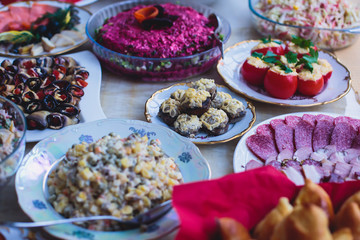 Beautifully decorated catering banquet table with different food snacks and appetizers on corporate christmas birthday party event or wedding celebration