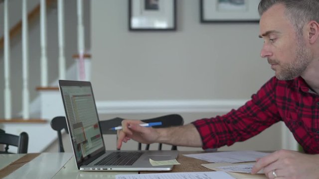 Blue collar man stressed with debt