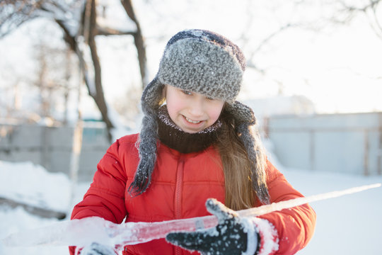 Girl surprised by the size of icicle