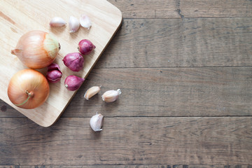 Onion and garlic on wood table with copy space