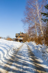 Mountain cottage among forests in winter. Landscape in the Silesian Beskids Mountains, Poland