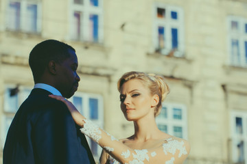 Loving couple of cute bride and african American groom