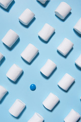 Sweeties marshmallows over blue table background.