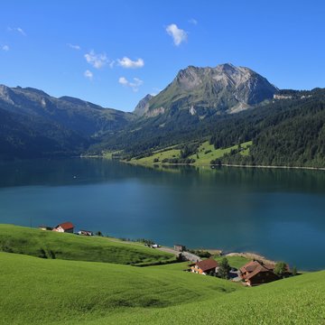 Green meadow, blue lake Wagital and mount Fluebrig