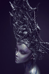 Mannequin in metallic headwear with chains