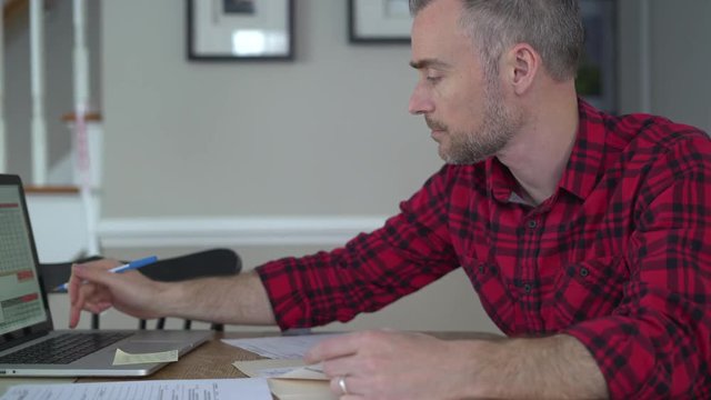 Bearded man doing paperwork