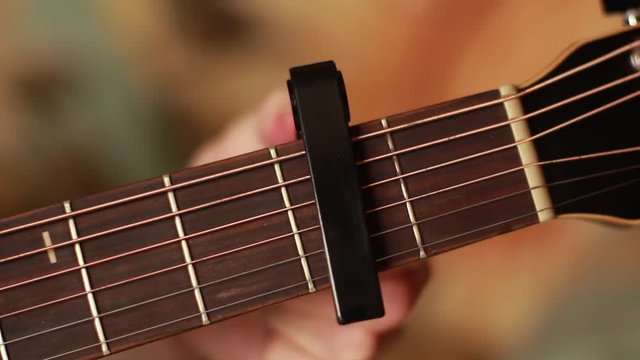 Taking off a capo from a guitar's neck