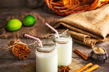 Fresh dairy products and cinnamon on an old wooden background, selective focus