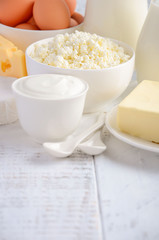 Fresh dairy products. Milk, cheese, brie, Camembert, butter, yogurt, cottage cheese and eggs on wooden table.