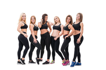 Fototapeta na wymiar Young fitness trainers in black tops and leggings