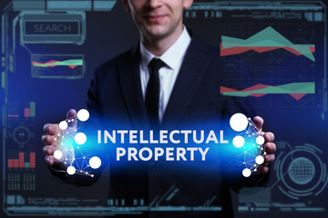 Business, Technology, Internet and network concept. Young businessman working on a virtual screen of the future and sees the inscription: Intellectual property