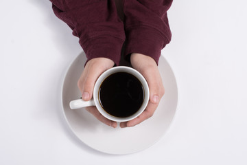 Woman's hands around a cup of coffee