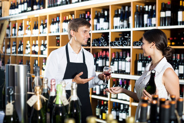 Seller in a wine house and visitor