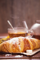 fresh hot tea with croissant