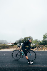 Cyclist standing in the rain 