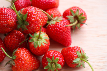 Red strawberries on wood background