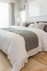 Fototapeta na wymiar set of pillows and blanket on bed in modern bedroom