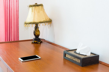 Workspace with mobile phone on wooden table