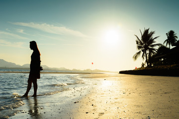 Silhouette of women at tropical beach during sunrise