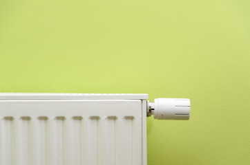 radiator valve on green background with negative space