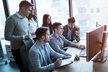 Software engineers working in office on project together