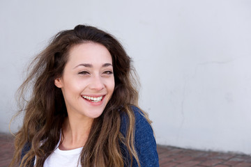 young woman sitting outside laughing