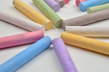 Close up of a lot of colored chalk pieces on on a white background. Back to school,education, arts, creative