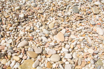 Wet pebble stones in the sun 